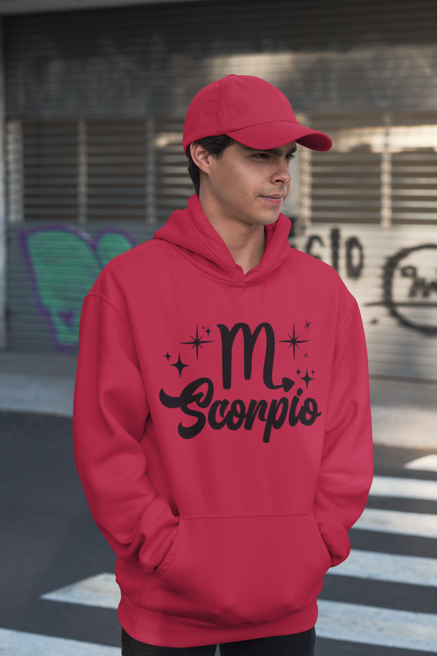 Person wearing a red hoodie with 'Scorpio' black text design, standing on a street.