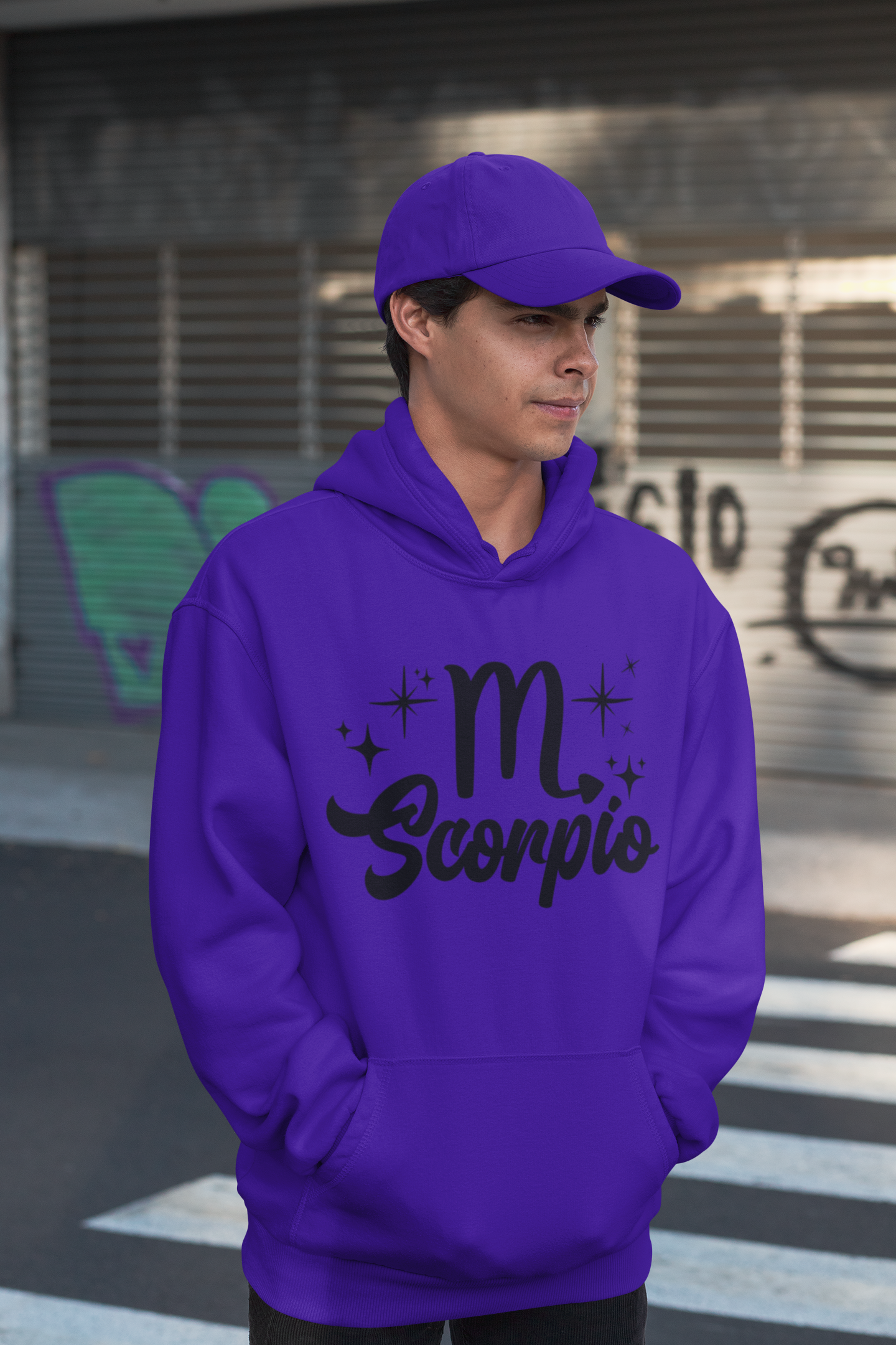 Person wearing a purple hoodie with 'Scorpio' black text design, standing on a street.