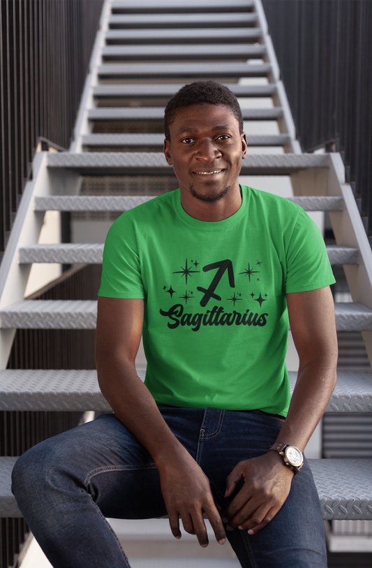 Man wearing a green t-shirt with 'Sagittarius' black text design sitting on stairs.