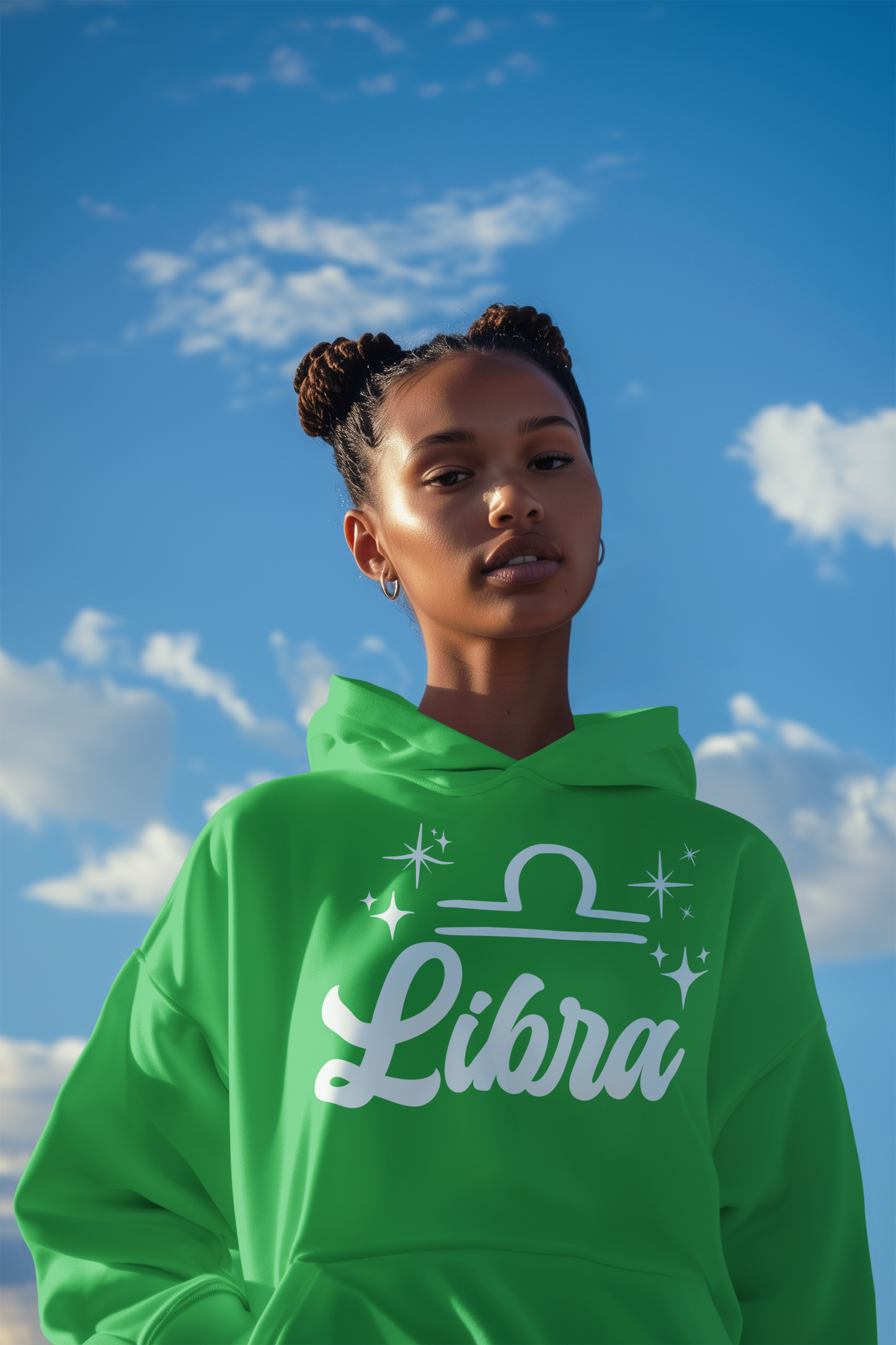 Person wearing a green 'Libra' hoodie - white text design against a blue sky with clouds