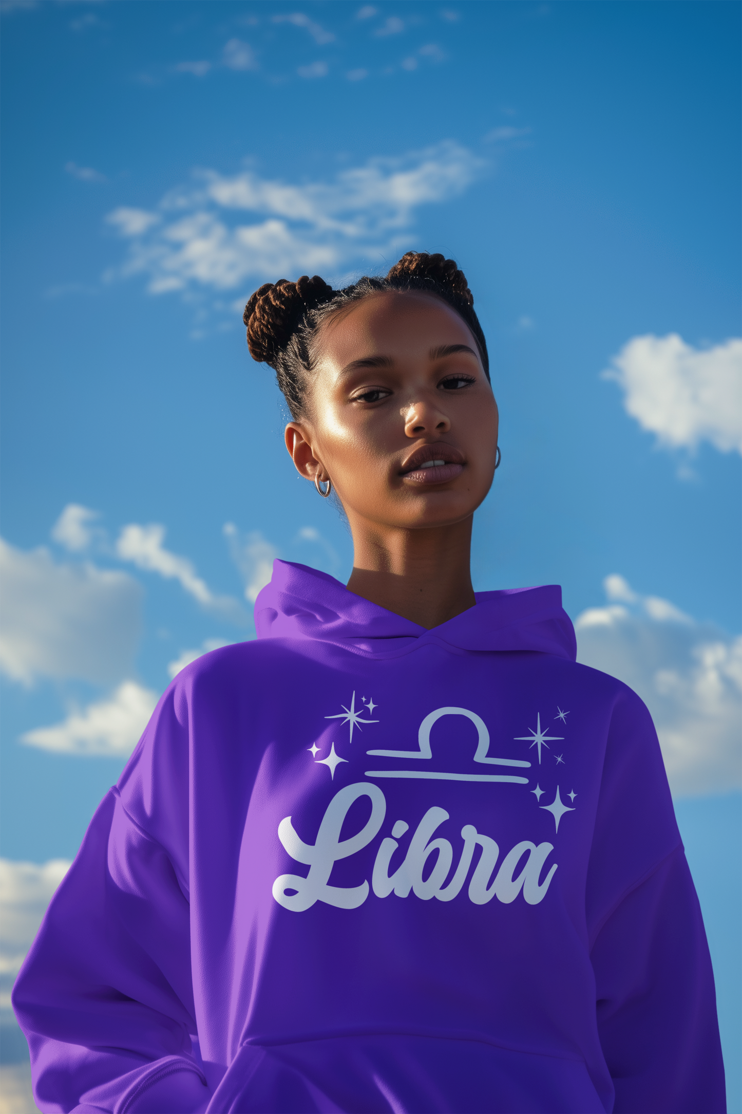 Person wearing a purple 'Libra' hoodie - white text design against a blue sky with clouds